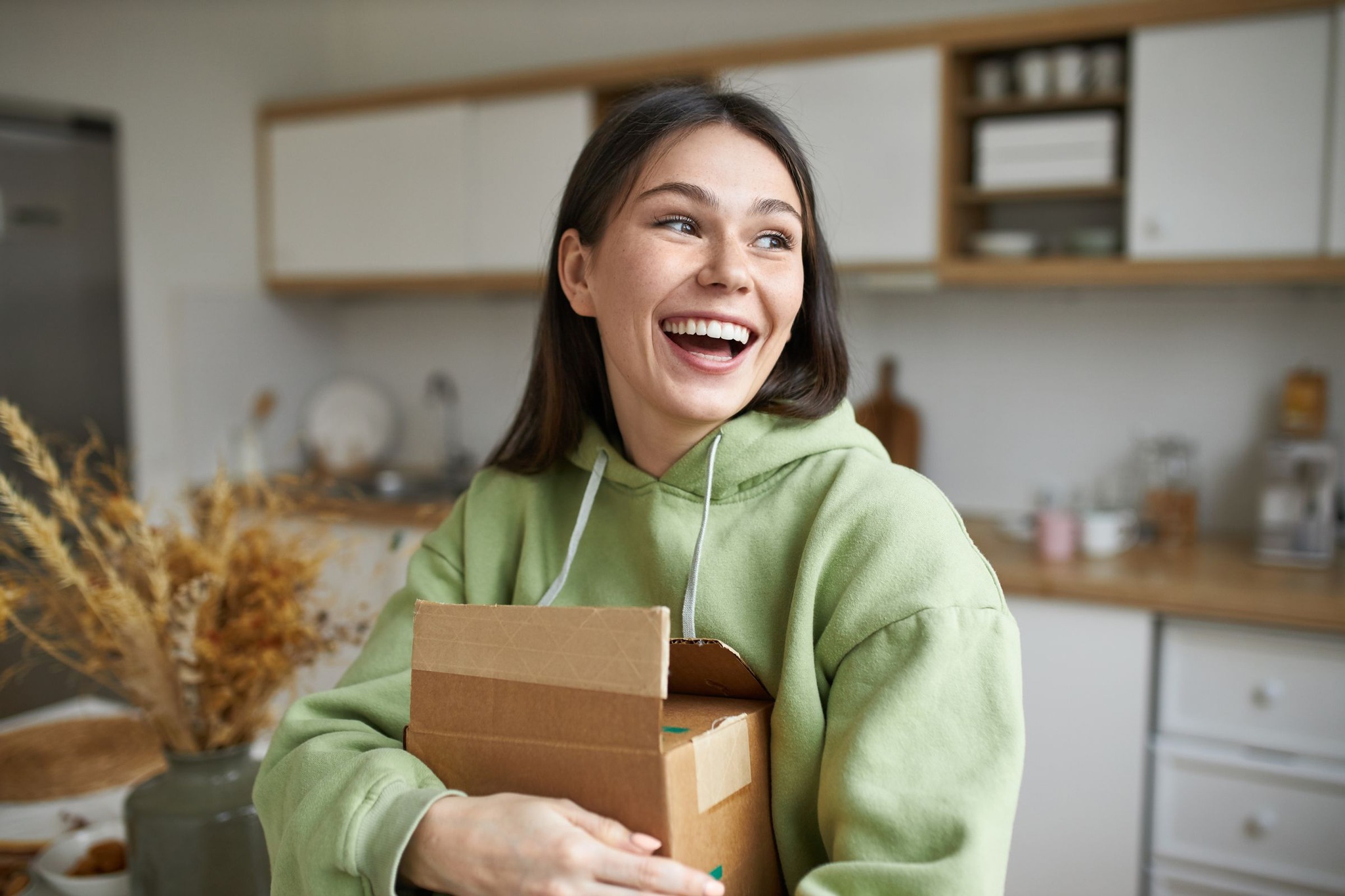 Smiling woman holding a delivery box